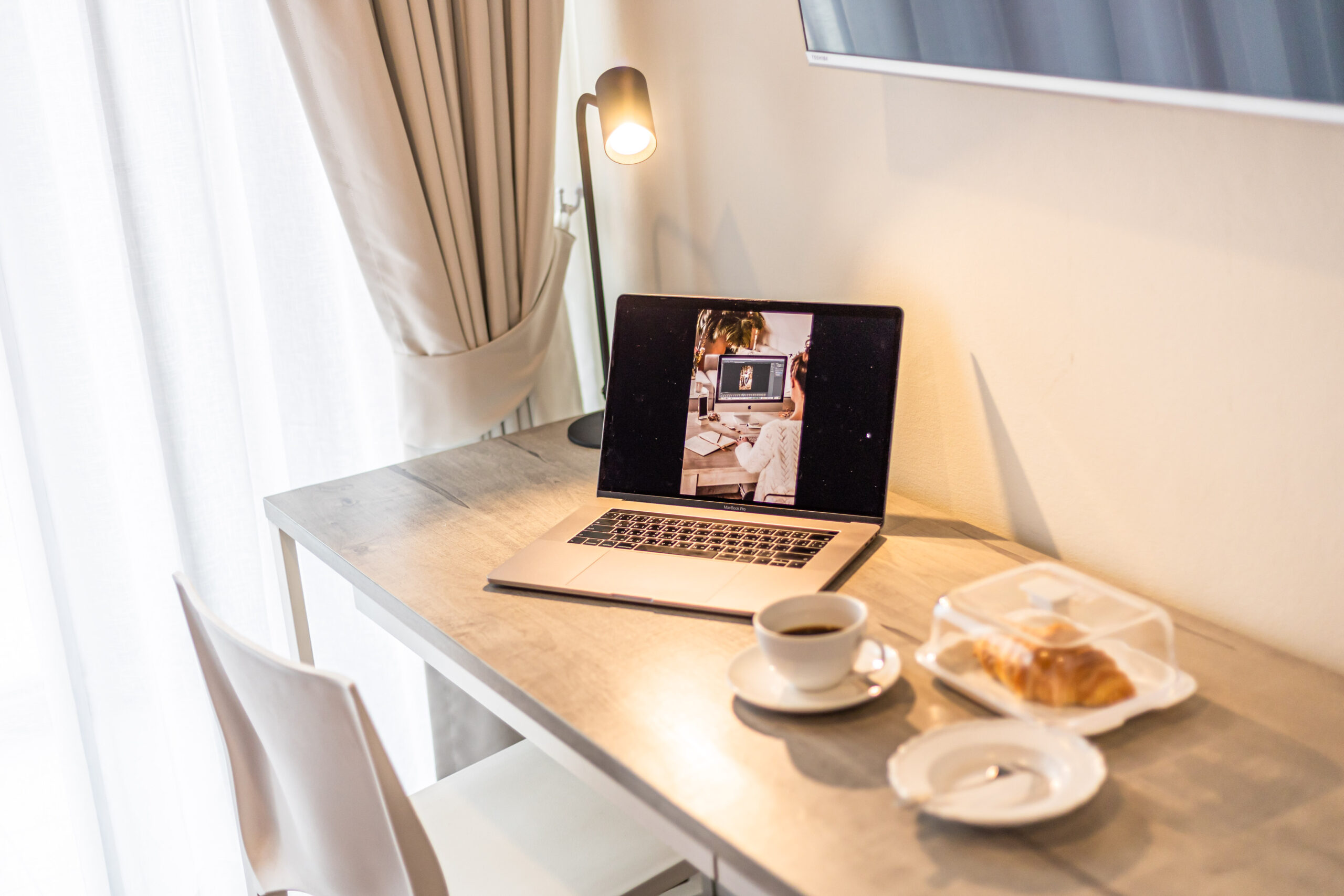 Cozy corner in guest room with welcome drinks and tablet at Red Crocodile Hotel