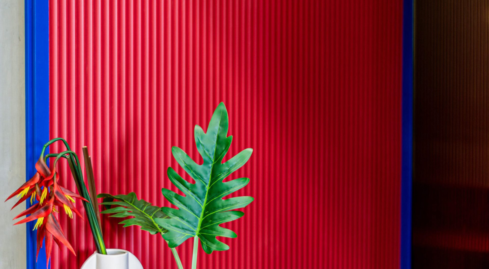 Vibrant red and blue interior wall decor at Red Crocodile Hotel in Samutprakan